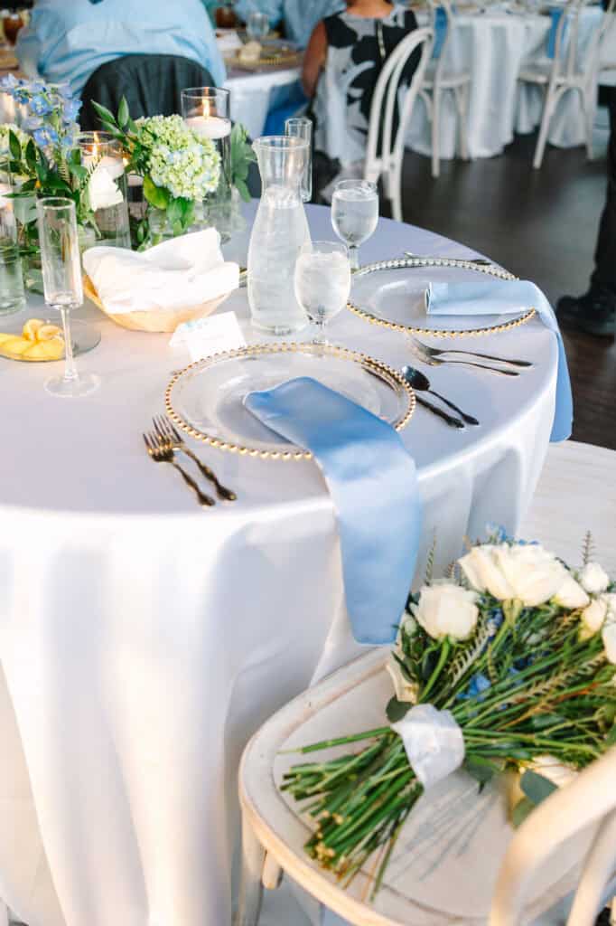 Lauren + Connor Wedding Reception place setting with a white rose and pale blue details