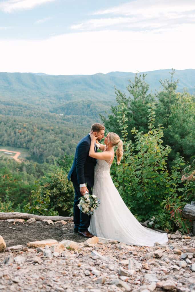 Lauren + Connor Wedding Close-up of the bride and groom kissing with a mountain ridge behind them