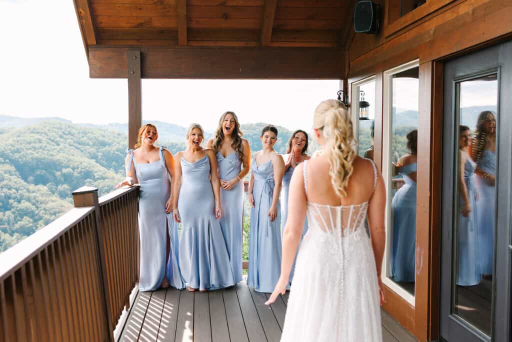 Lauren + Connor Wedding Bridesmaids smile at the bride during their balcony reveal