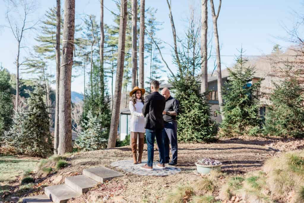 Laura + Steve Elopement Wide view of the outdoor ceremony among tall trees