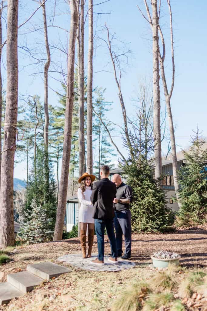 Laura + Steve Elopement Couple holding hands during their wooded elopement ceremony