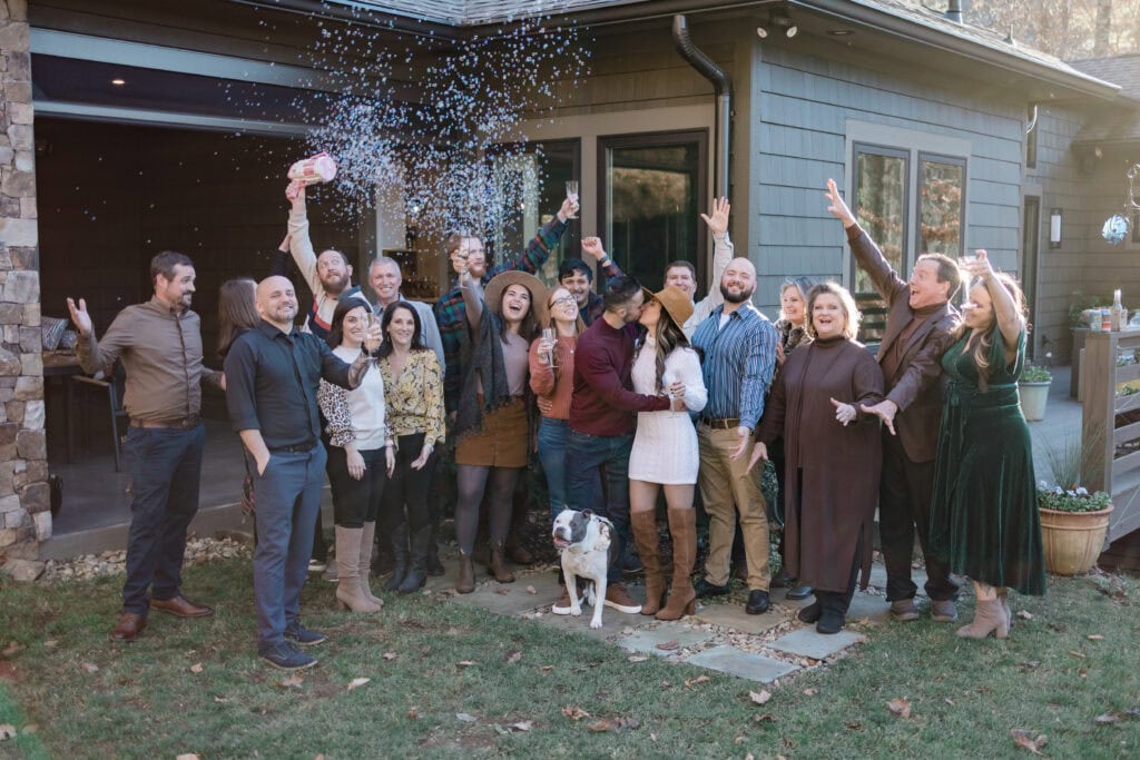 Laura + Steve Elopement Big family group celebrating the couple in front of the house