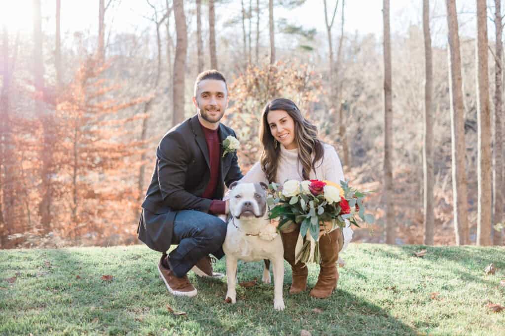 Laura + Steve Elopement Newlyweds kneeling with their dog on the lawn