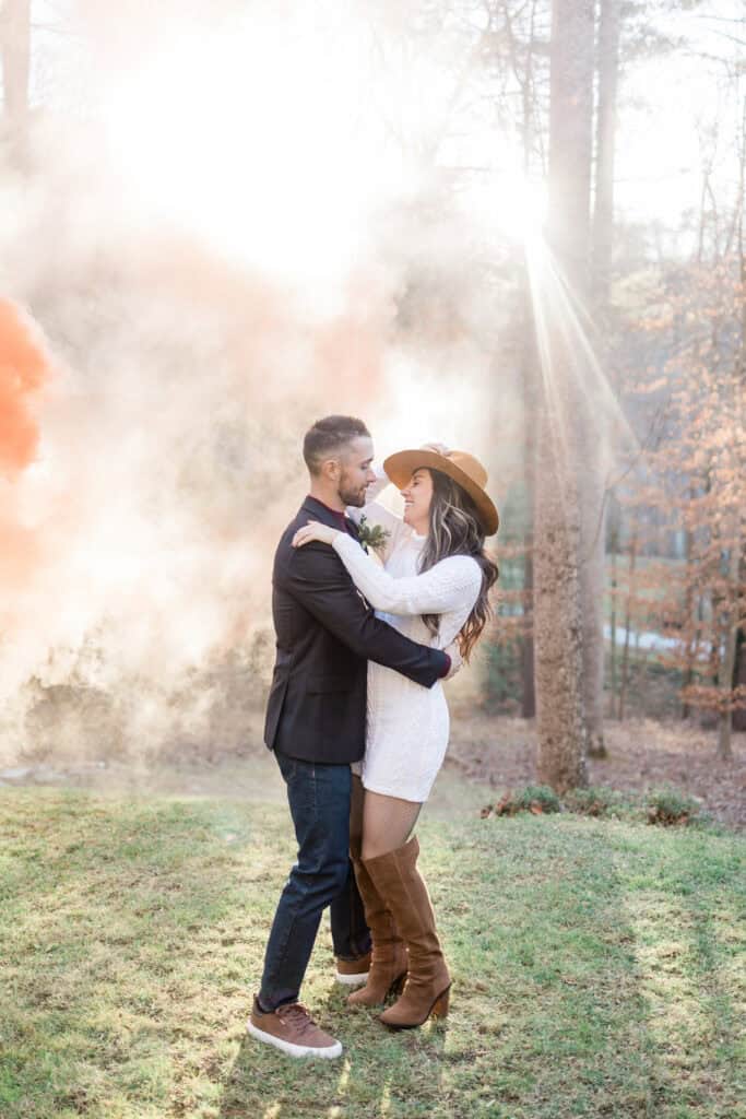 Laura + Steve Elopement Couple kissing as colored smoke drifts behind them