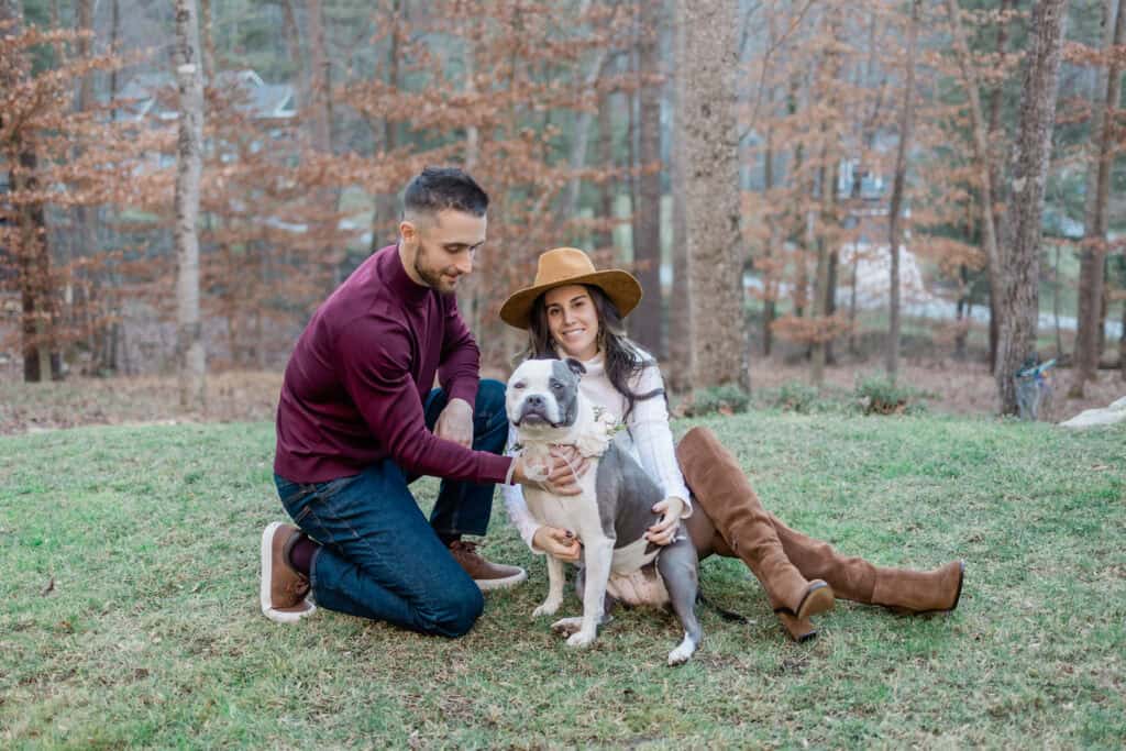 Laura + Steve Elopement Couple laughing with their dog in the backyard