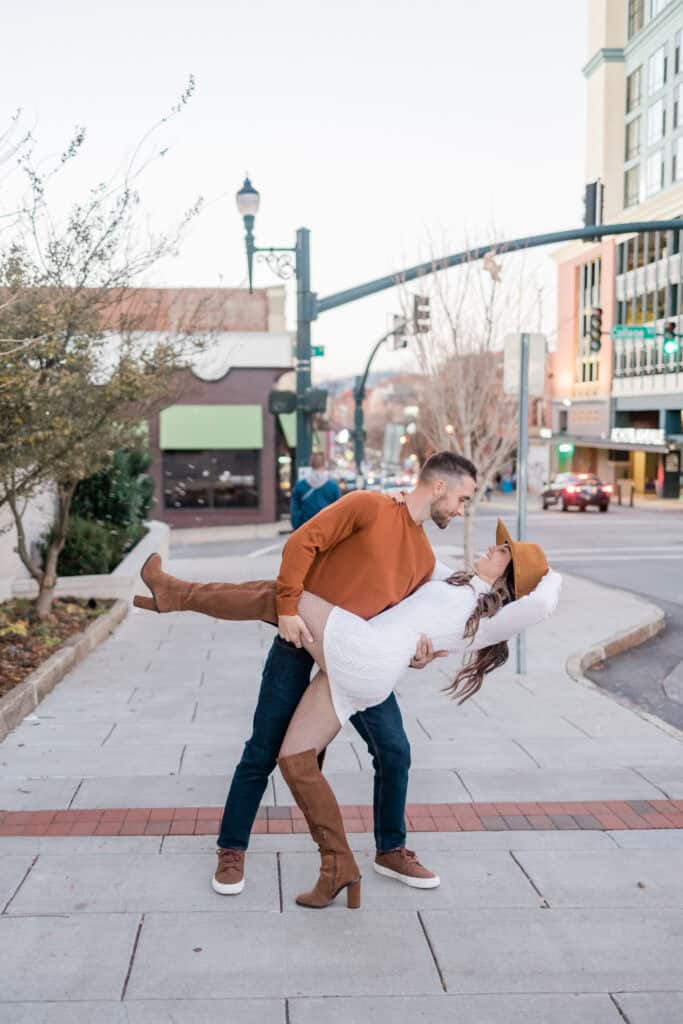 Laura + Steve Elopement Groom dipping the bride on a downtown Asheville street