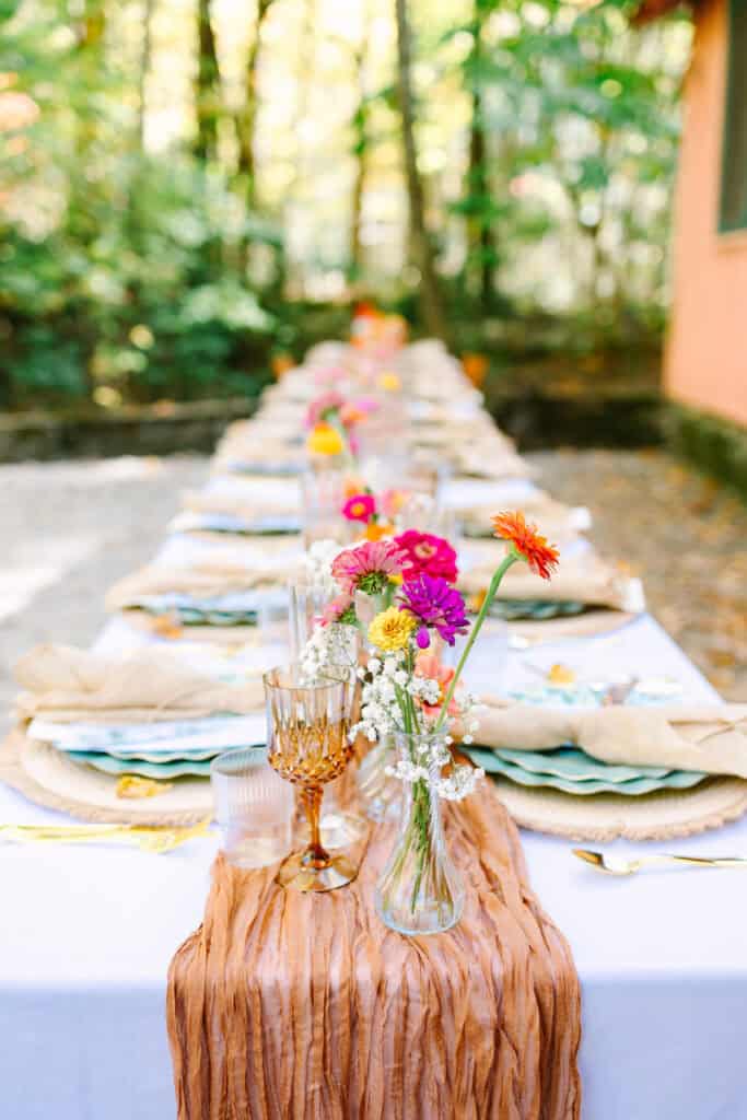 Thaís + Nick Wedding Long DIY reception table on the stone patio at Spence Cabin