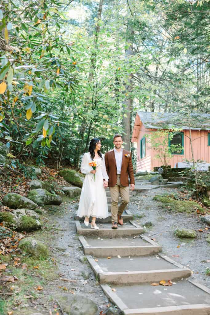 Thaís + Nick Wedding Bride and groom walking down the stone steps to their Spence Cabin ceremony