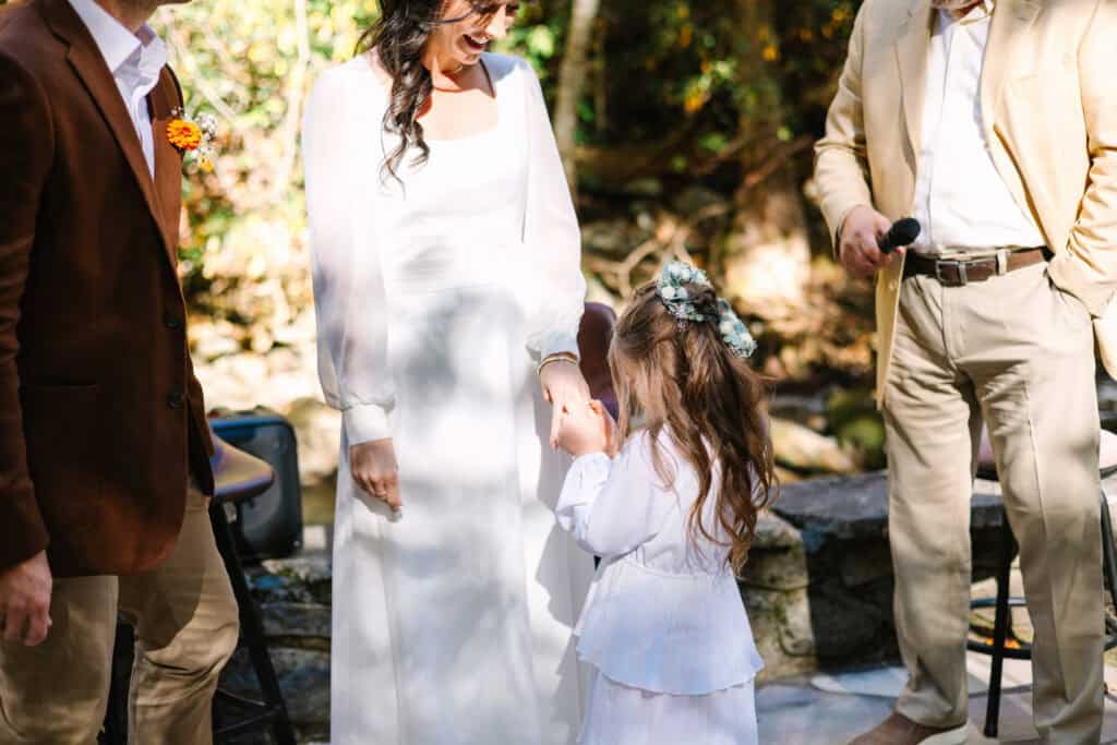 Thaís + Nick Wedding Little girl standing with the couple during their wedding ceremony