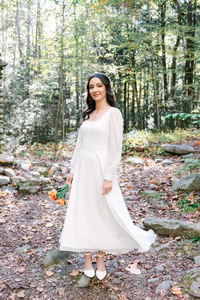 Thaís + Nick Wedding Bride twirling her long sleeve wedding dress in the forest