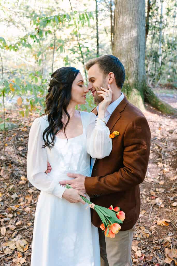 Thaís + Nick Wedding Groom pulling the bride close for a forest portrait