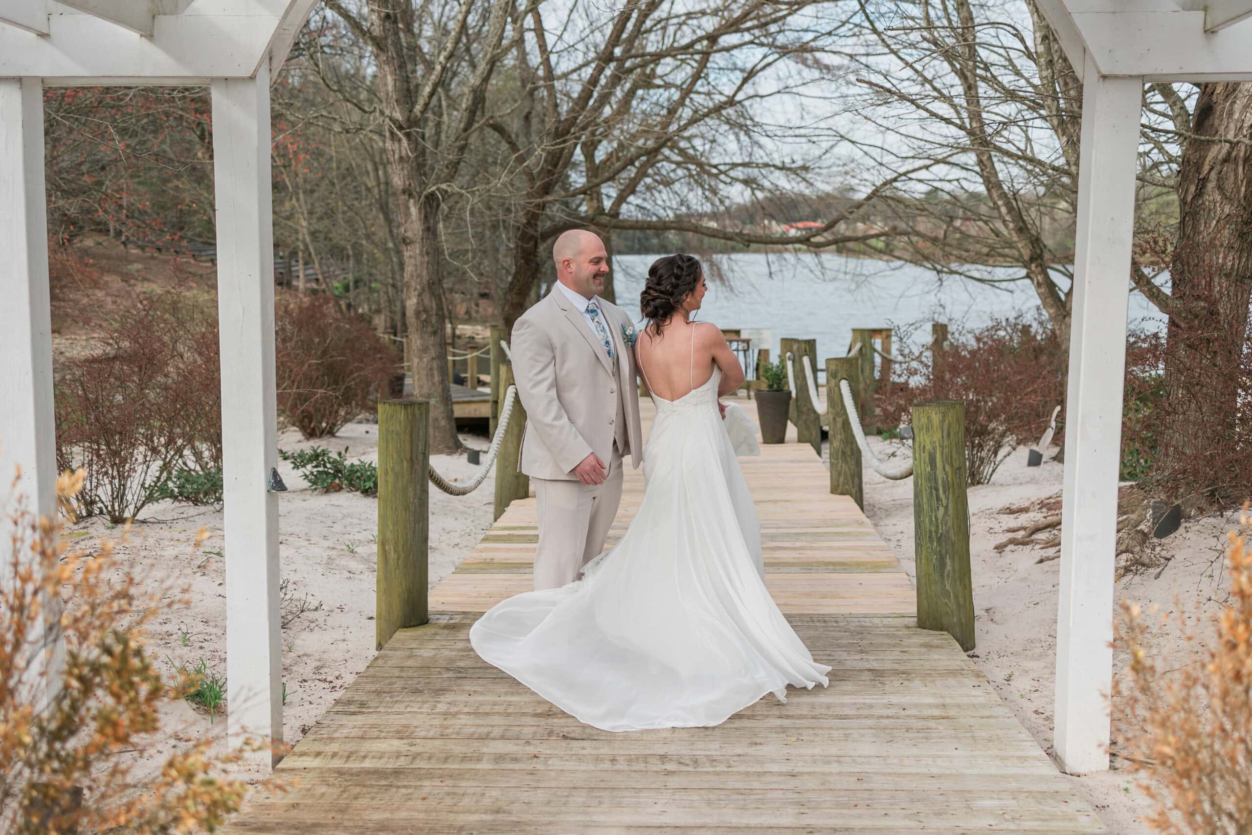 Wide view of the couple on the lakeside dock