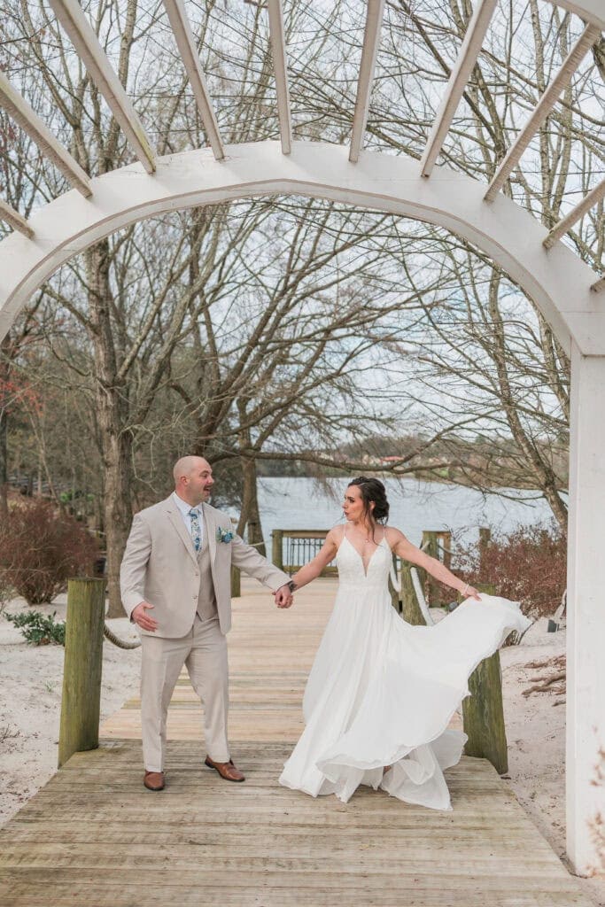 Sarah + Jake Wedding Groom twirling the bride under the arbor