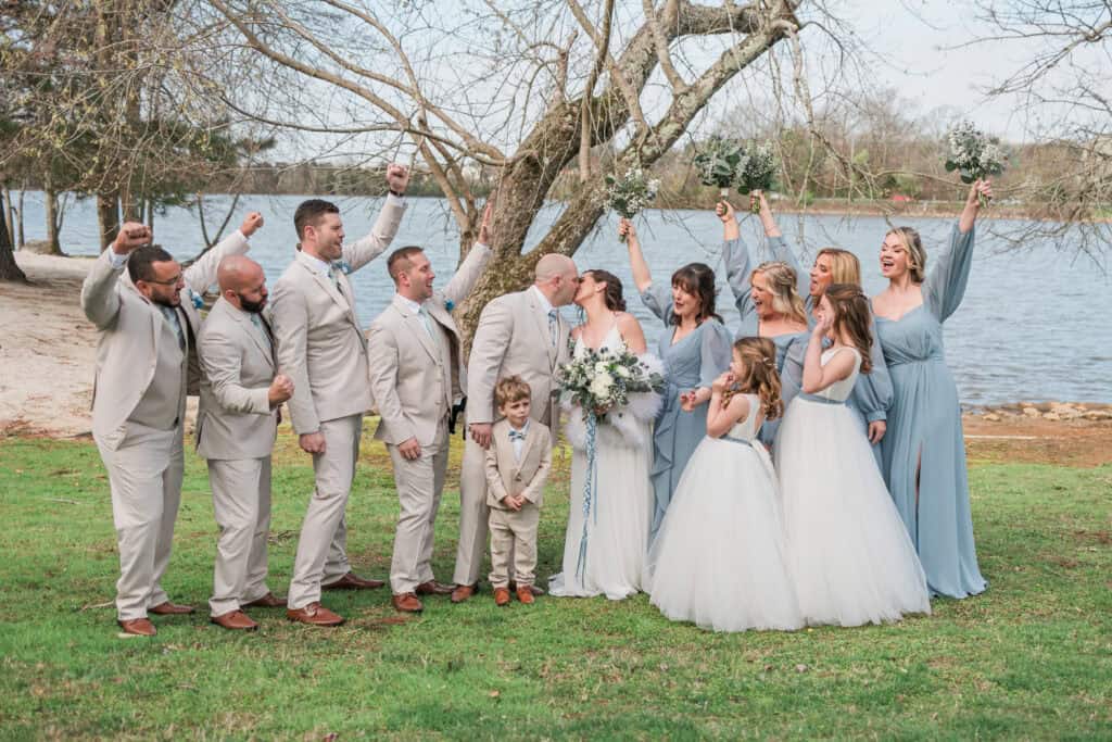 Sarah + Jake Wedding Wedding party laughing together on the lawn