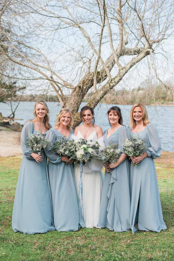 Sarah + Jake Wedding Bride with her bridesmaids in dusty blue gowns