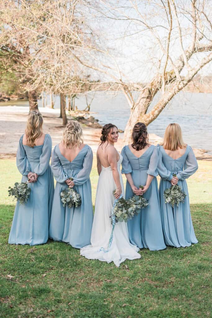 Sarah + Jake Wedding Bride and bridesmaids looking out at the lake