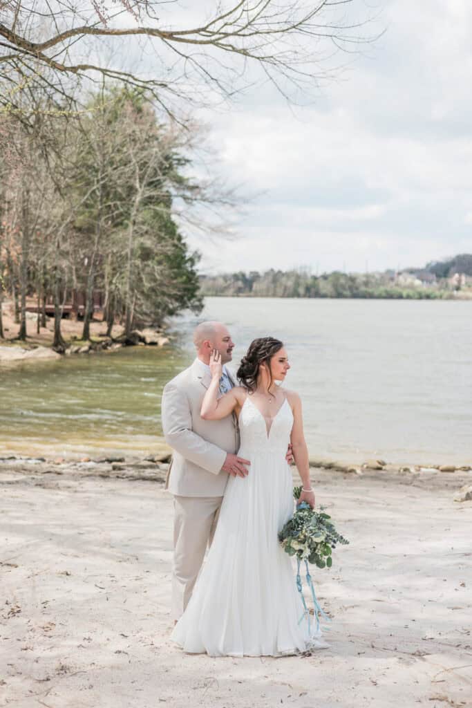 Sarah + Jake Wedding Newlyweds by the water on the sandy beach