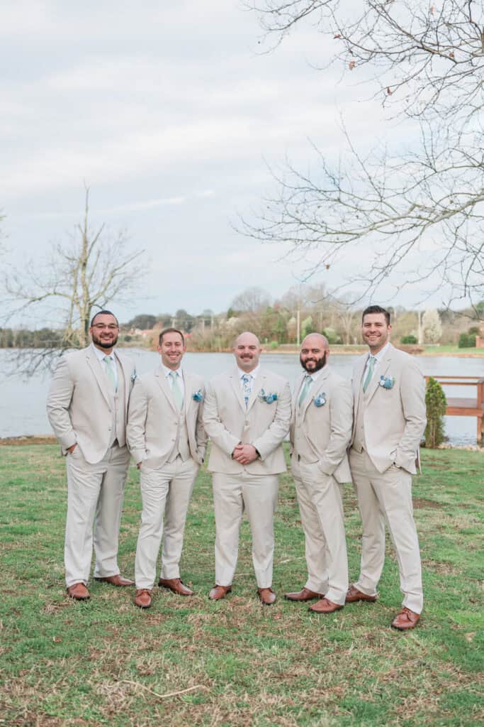 Sarah + Jake Wedding Groomsmen standing together in matching tan suits