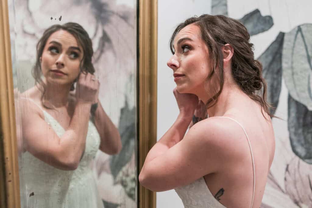 Sarah + Jake Wedding Bride looking over her shoulder while getting ready